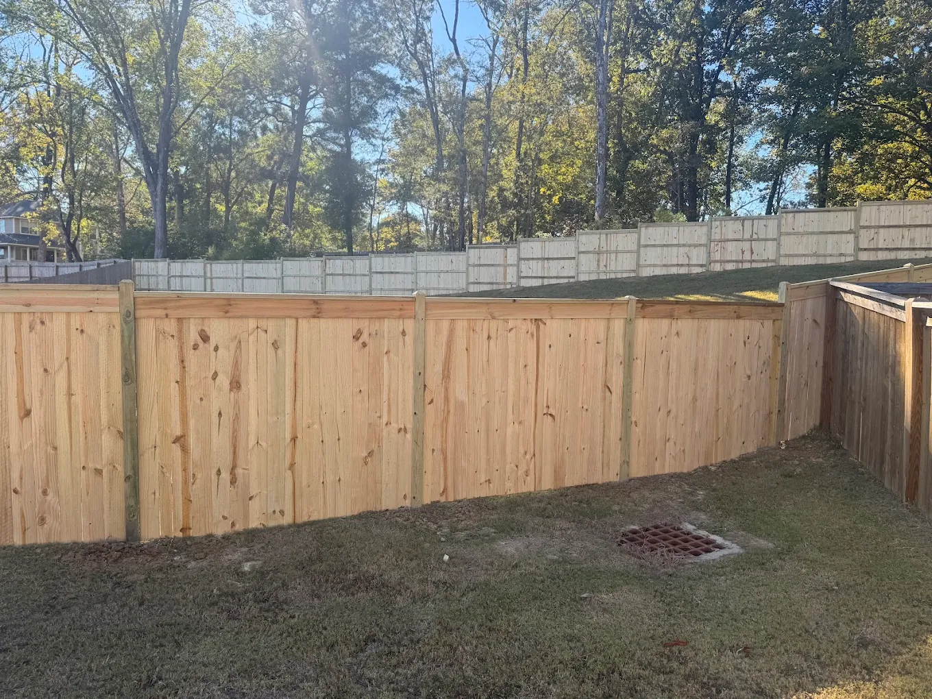 Board-on-board wood privacy fence installation in Starkville, Mississippi by Fortenberry Project Solutions