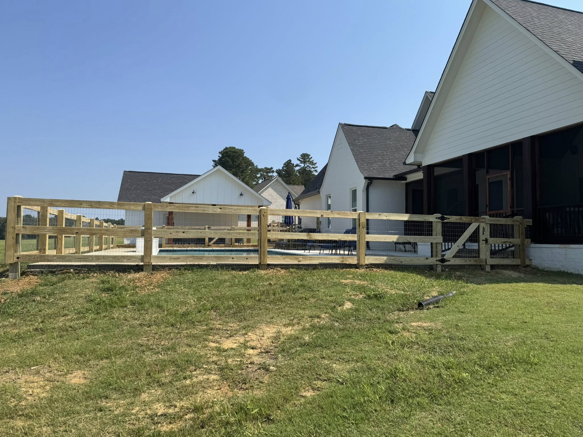 Post-and-rail fence on rural acreage - farm fence installation in the Golden Triangle, Mississippi